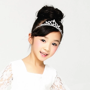 Detailed view of silver kids crown headband with sparkling rhinestones on child model
