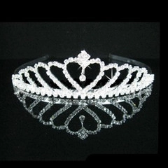 Macro shot of silver rhinestone princess tiara with heart design and drop pendant