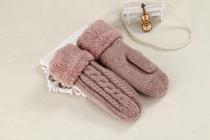 Detailed view of pink knitted mittens featuring cable knit texture and faux fur cuffs