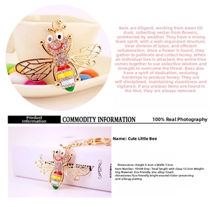 Macro detail of golden bee keychain featuring colorful enamel and inlaid rhinestones