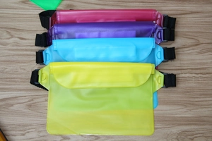 Assorted colorful PVC waterproof waist bags stacked for swimming and outdoor water sports