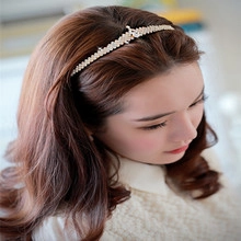Detail shot of golden rhinestone crown headband worn by a model for elegant styling