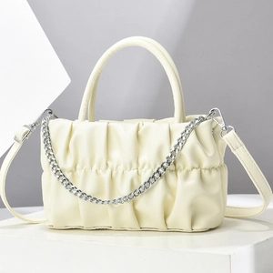 Detail of ruched pleated handbag with silver chain and detachable leather shoulder strap