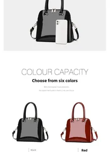 Detail of glossy shell-shaped handbags in black and red with gold hardware and straps