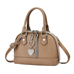 Minimalist camel leather doctor bag with silver tassel and heart charm pendant