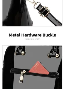 Detail of glossy black patent leather handbag with gold metal hardware and back zipper pocket