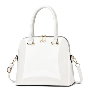 Glossy white patent leather shell handbag with gold hardware and adjustable strap