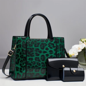 Three-piece handbag set featuring green leopard tote and black patent leather pouches