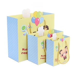 Three assorted sizes of cartoon panda gift bags with yellow woven handles and balloon prints