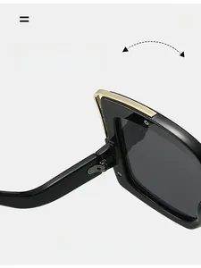 Detail showing the durable metal texture hinge of the oversized square sunglasses