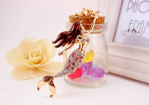 Detailed close-up of golden mermaid keychain featuring sparkling rhinestones and enamel finish