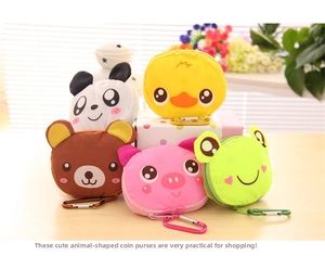 Foldable cartoon animal shopping bags with metal carabiners on light wood surface