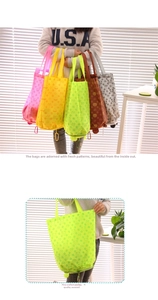 Detail of foldable cartoon shopping bags with metal carabiners for easy attachment