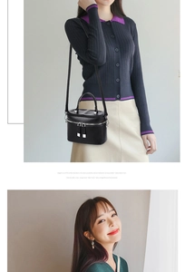 Detail of black quilted bucket bag featuring dual zippers and detachable shoulder strap