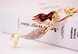 Detailed view of rhinestone mermaid keychain with pink crystals and enamel finish