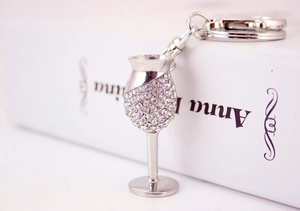 Close-up of sparkling rhinestone-encrusted wine glass keychain with silver lobster clasp