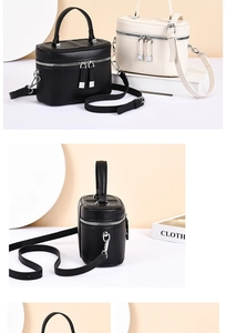 Detail view of the sleek cylinder crossbody bag with double silver zippers and matte PU finish