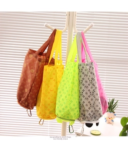 Foldable cartoon animal shopping bags in five colors with hooks on a white rack