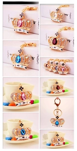 Detailed views of crystal crown keychains with teardrop gemstones in various colors