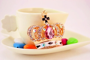 Macro detail of crown keychain with pink teardrop crystal and rhinestones in a cup