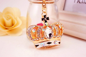 Close-up of golden crown keychain with crystals, rhinestones and enamel details