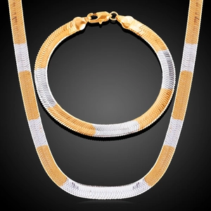 Detail of two-tone gold and silver flat herringbone chain necklace and bracelet set