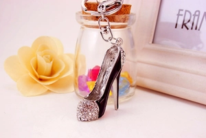 Macro shot of high heel keychain with sparkling rhinestones and black enamel finish