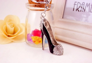 Macro detail of high heel keychain with black enamel and sparkling rhinestones