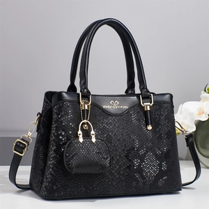 Elegant black faux crocodile skin handbag with top handles and adjustable shoulder strap