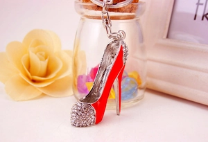 Macro view of a red high heel keychain with sparkling crystals and silver alloy details