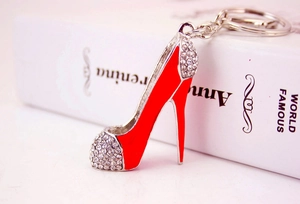 Macro view of a red enamel high heel keychain with sparkling rhinestone accents