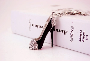 Macro view of high-heeled shoe keychain with black enamel finish and sparkling rhinestones