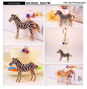 Macro detail of zebra keychain with sparkling black and white rhinestones on gold base