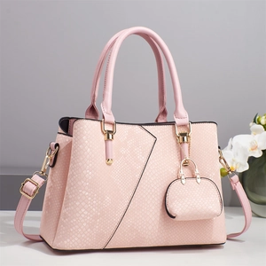 Elegant light pink embossed leather handbag with crossbody strap and orchid background