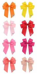 Close-up of handmade polyester grosgrain ribbon hair bows in eight vibrant colors