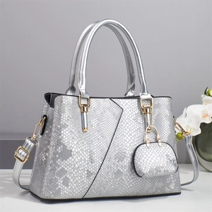 Elegant silver snake print tote bag with golden hardware and mini pouch charm
