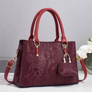 Elegant wine red snakeskin embossed handbag with gold hardware and V-stitch design