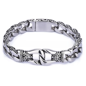 Detailed macro view of vintage stainless steel cuban chain bracelet with totem engraving
