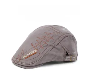 Detail of grey cotton flat cap featuring side embroidery and adjustable metal strap buckle