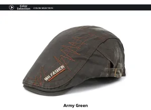 Detail of army green washed cotton newsboy cap with orange stitching and metal buckle