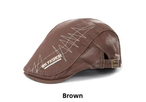 Detail view of the brown cotton newsboy cap with embroidery and adjustable metal buckle