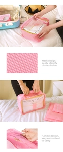 Close-up of pink travel packing cubes with breathable mesh and sturdy handles