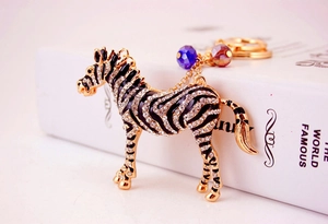 Detail view of a gold zebra keychain with sparkling rhinestones and colorful crystal beads