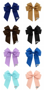 Grosgrain ribbon hair bows in eight colors including navy, yellow, and pink with clips