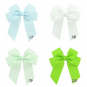 Detailed view of handmade double-layered grosgrain ribbon hair bows in four pastel colors