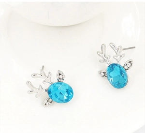 Close-up of reindeer stud earrings with blue crystal gemstones and silver antlers