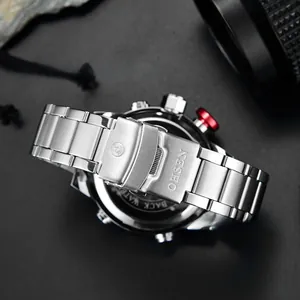 Detailed close-up of the stainless steel folding clasp and red functional button on watch