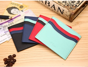 Cross-grain leather card holders in black, navy, red, and mint green with multi-card slots