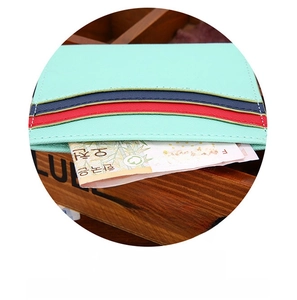 Detail of mint green cross-grain leather wallet with multi-slot card holder design