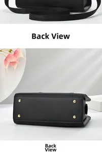 Detail view of black lychee grain leather handbag featuring protective golden metal feet